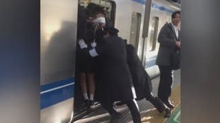 Professional Pushers Shove Passengers Onto Busy Tokyo Train [upl. by Trella136]